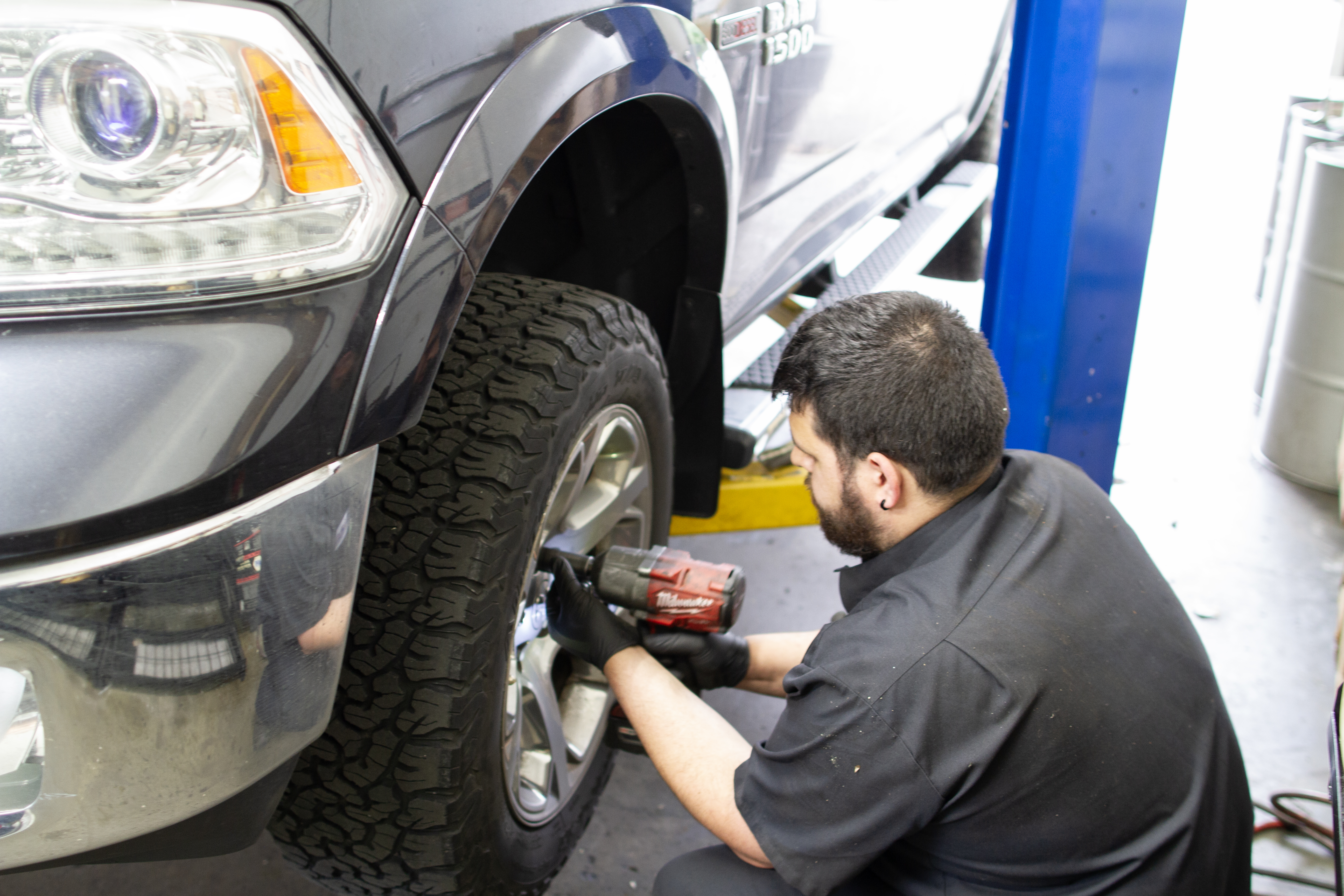 Truck suspension repair McCabe’s technician working on the front wheel of a pickup truck